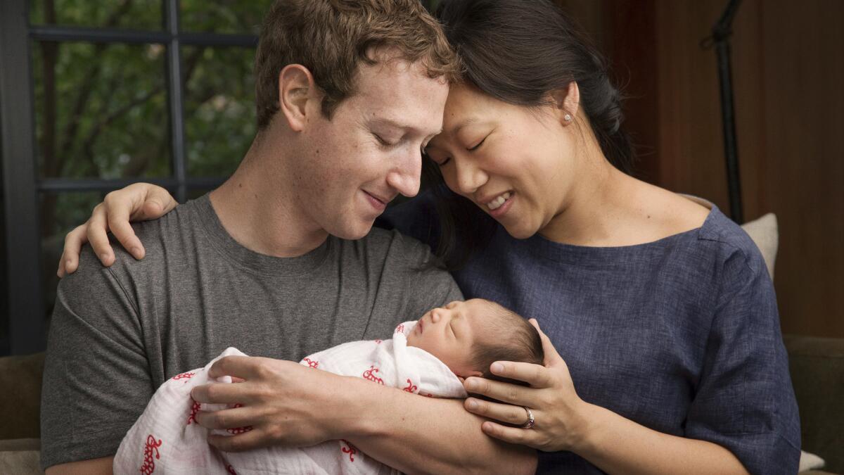 Mark Zuckerberg and Priscilla Chan with their daughter Maxima Chan Zuckerberg -- sans Jedi robe.