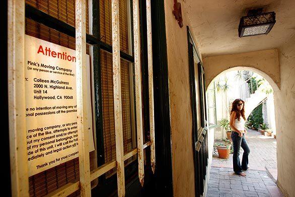 Janet Eisner, a four-year resident of Villa Valentino in Hollywood, stands outside an apartment that has a note from a tenant warning a moving company not to remove any items. The new owner of the circa-1920s apartment complex has tried to evict residents, claiming the building has no safe water, no proper security, a rodent and termite infestation and a carbon monoxide leak. Residents say that isn't true and are fighting to stay.