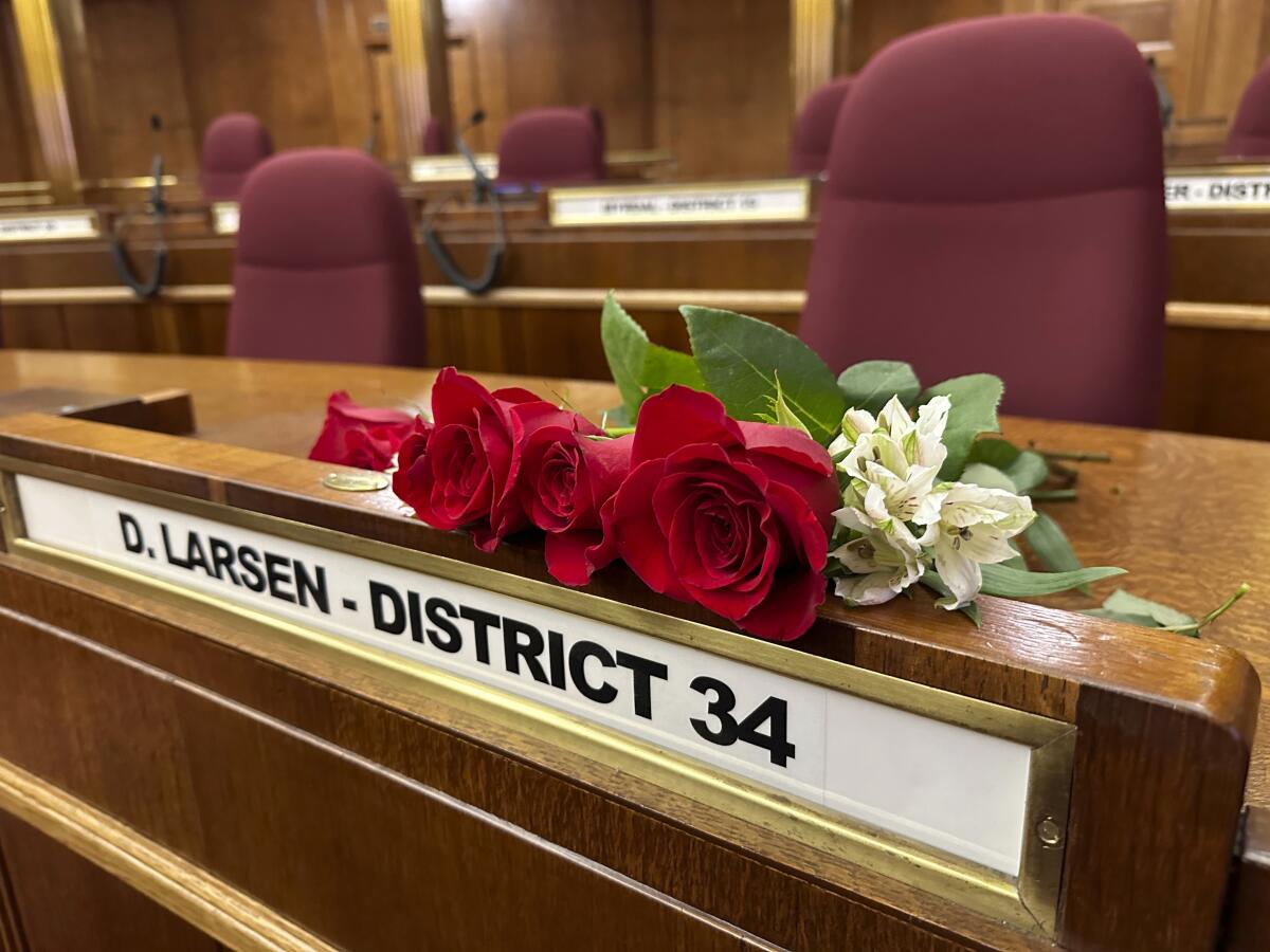 Roses resting on the desk of North Dakota state Sen. Doug Larsen