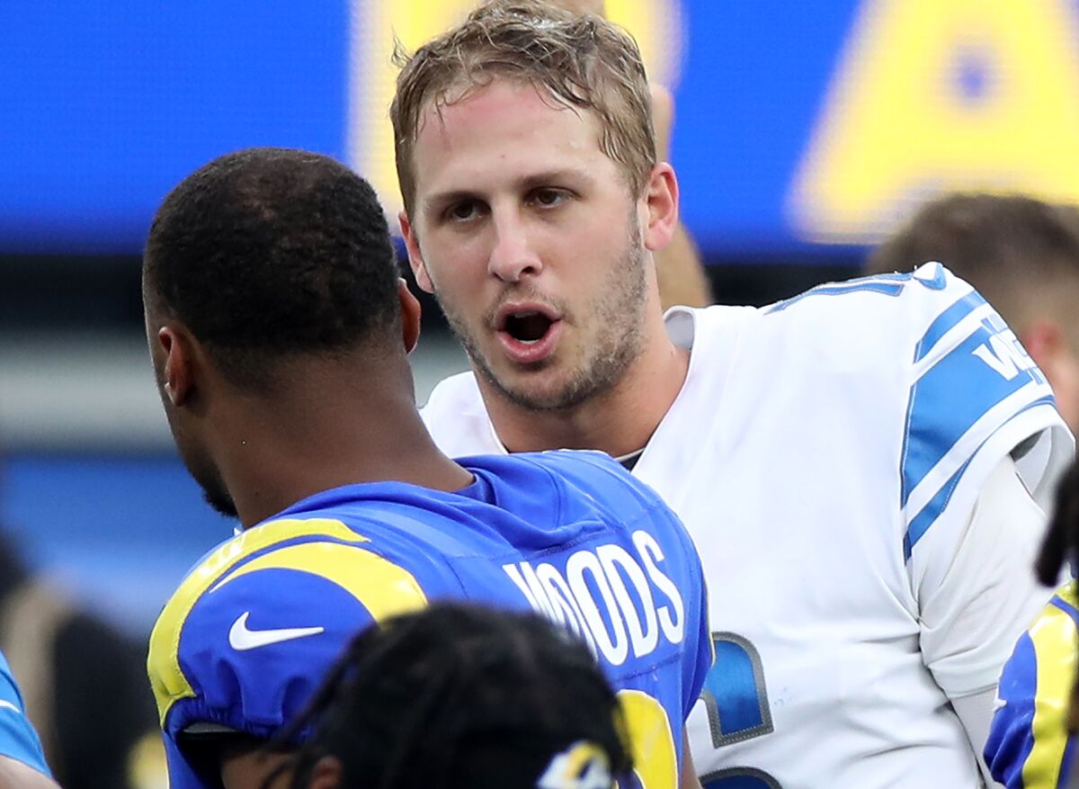Lions quarterback Jared Goff talks with former teammate,  wide receiver Robert Woods, after the game at SoFi Stadium.