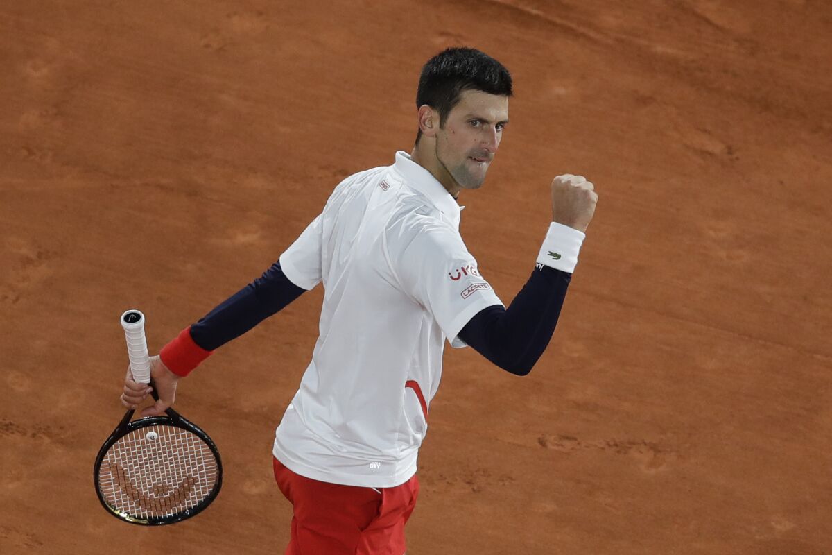 Novak Djokovic clenches his fist after scoring a point against Pablo Carreno Busta.
