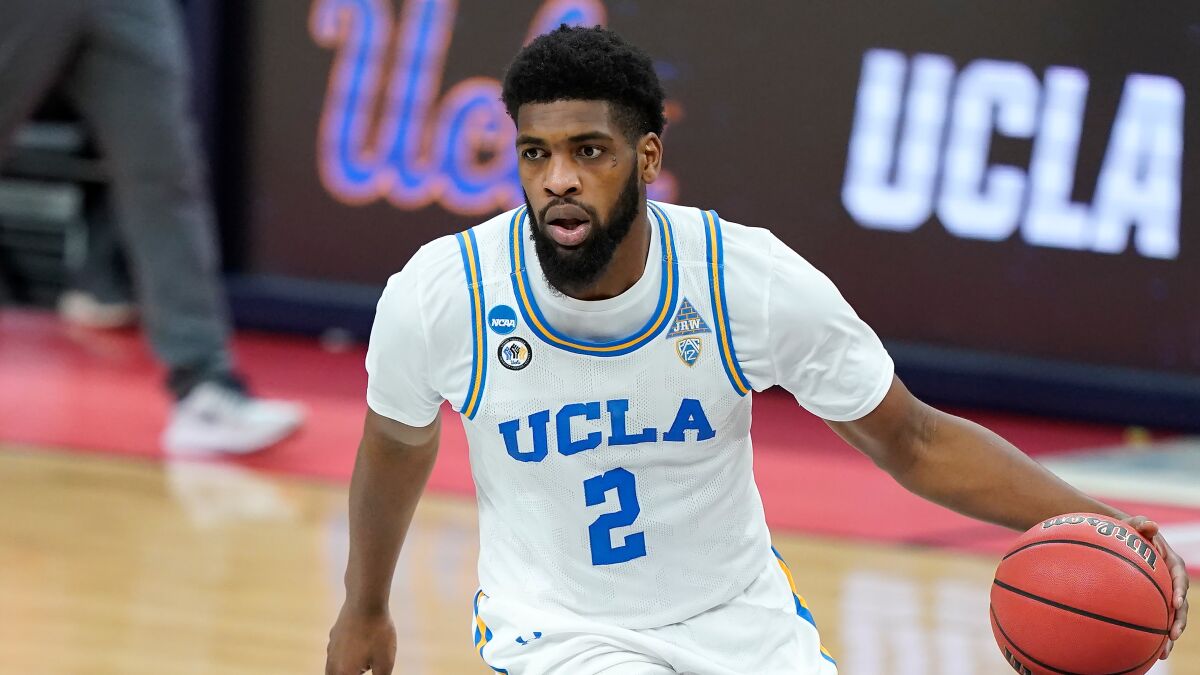 UCLA forward Cody Riley dribbles the basketball in the half-court offense.