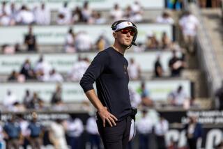 USC coach Lincoln Riley wears sunglasses, rests his hands on hips and looks at Colorado scoreboard during a tight game