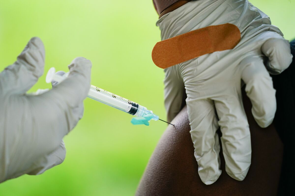 FILE - In this Sept. 14, 2021, file photo, a health worker administers a dose of a Pfizer COVID-19 vaccine during a vaccination clinic in Reading, Pa. Pfizer, Thursday, April 14, 2022, wants to expand its COVID-19 booster shots to healthy 5- to 11-year-olds. U.S. health authorities already urge everyone 12 and older to get one booster dose for the best protection. And those 50 and older have the option of a second booster. (AP Photo/Matt Rourke, File)