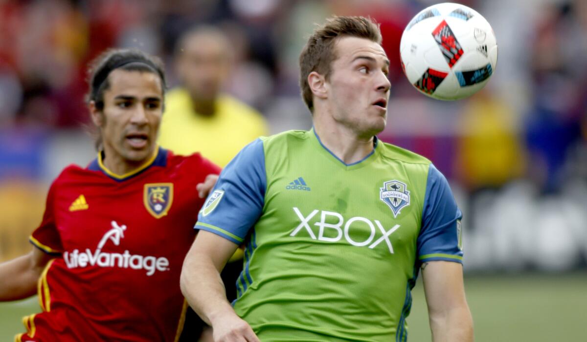 Seattle's Jordan Morris, right, tries to track down a pass against Real Salt Lake's Tony Beltran during an MLS game March 12.