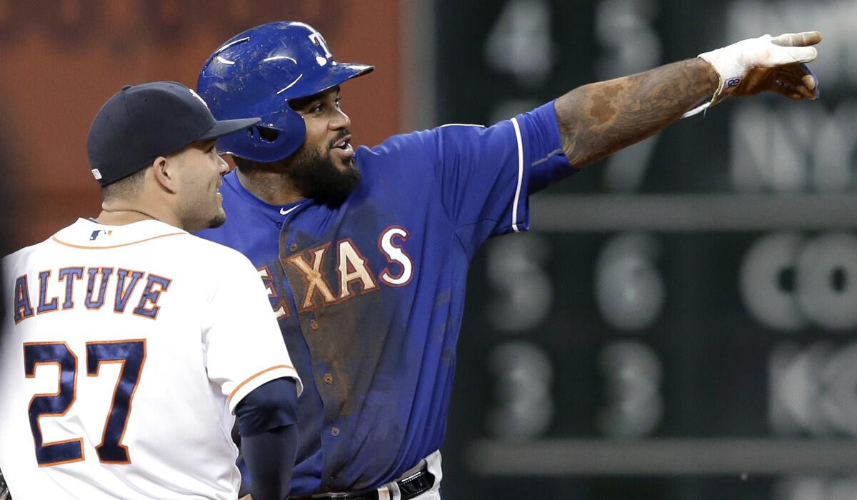 Rangers slugger Prince Fielder points out the video replay to Astros second baseman Jose Altuve during a review in a game on Tuesday. Fielder had tried to stretch a hit into a double and was called out on a close play.