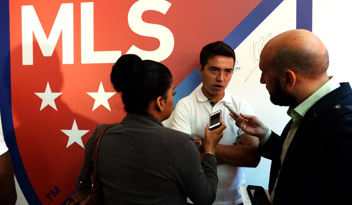 Chivas USA forward Erick Torres speaks to reporters during the unveiling of the new MLS logo in New York.