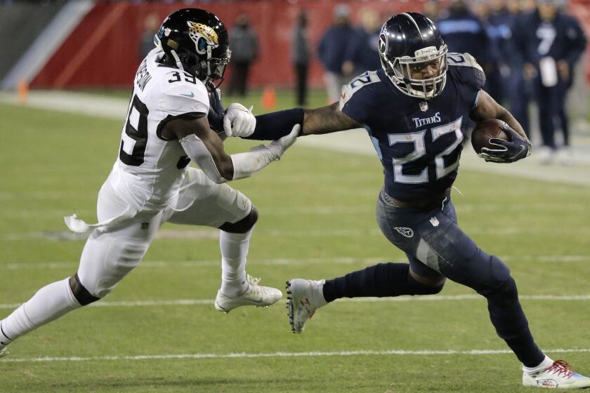 Tennessee Titans running back Derrick Henry (22) runs against Jacksonville Jaguars free safety Tashaun Gipson (39) during the second half of an NFL football game, Thursday, Dec. 6, 2018, in Nashville, Tenn. The Tennessee Titans won 30-9. (AP Photo/James Kenney)