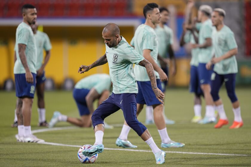 Brazil's Dani Alves, center, practices with teammates during a training session at the Grand Hamad stadium in Doha, Qatar, Thursday, Dec. 1, 2022. Brazil will face Cameroon in a group G World Cup soccer match on Dec. 2. (AP Photo/Andre Penner)