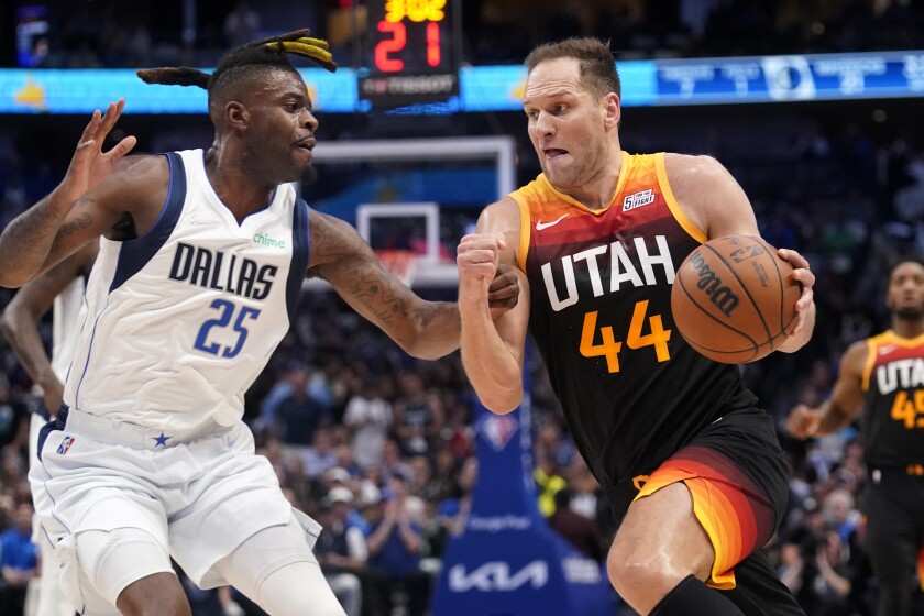 Dallas Mavericks forward Reggie Bullock, left, defends as Utah Jazz forward Bojan Bogdanovic during a playoff game in April.