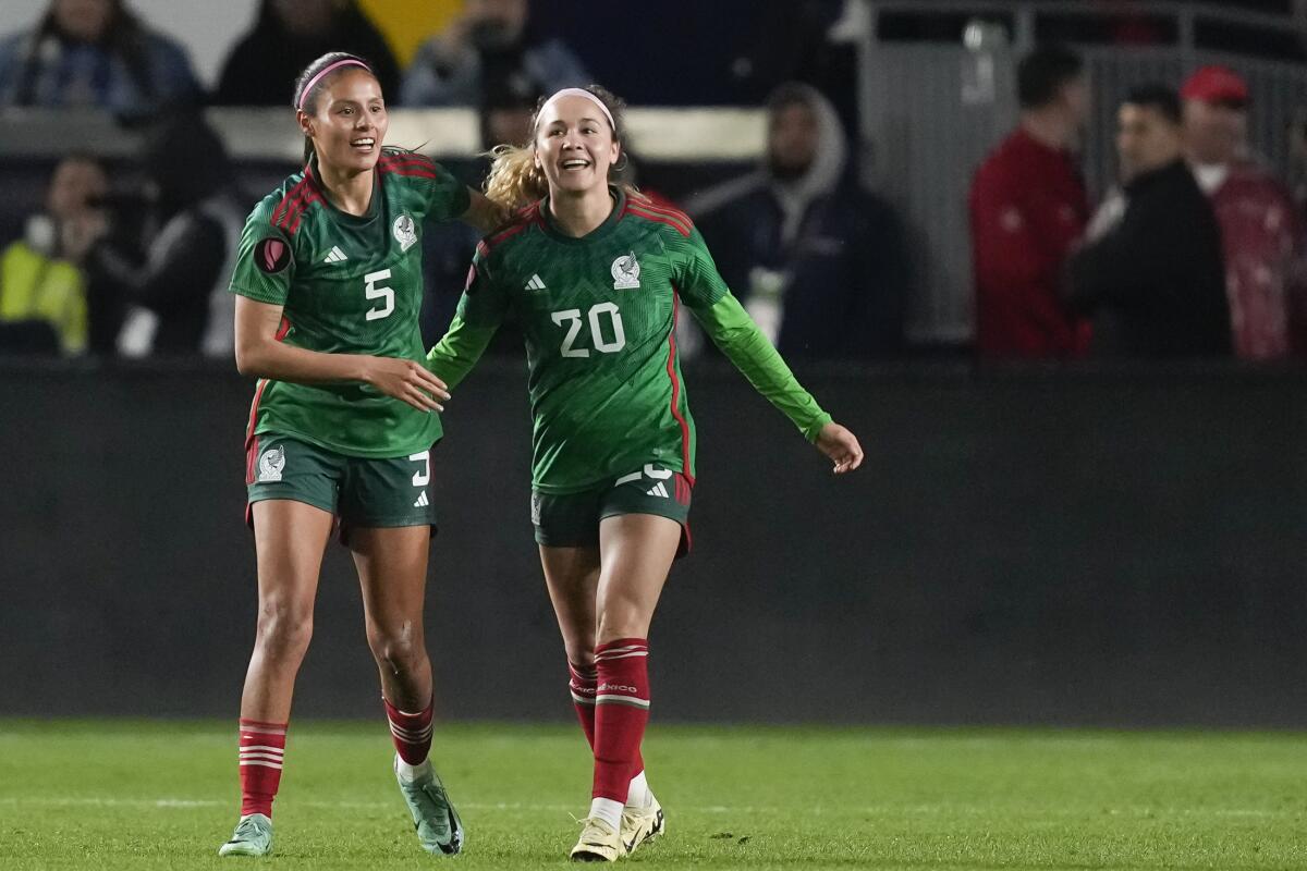 Mexico midfielder Mayra Pelayo, right, celebrates with teammate Karen Luna after scoring against the U.S. on Monday.
