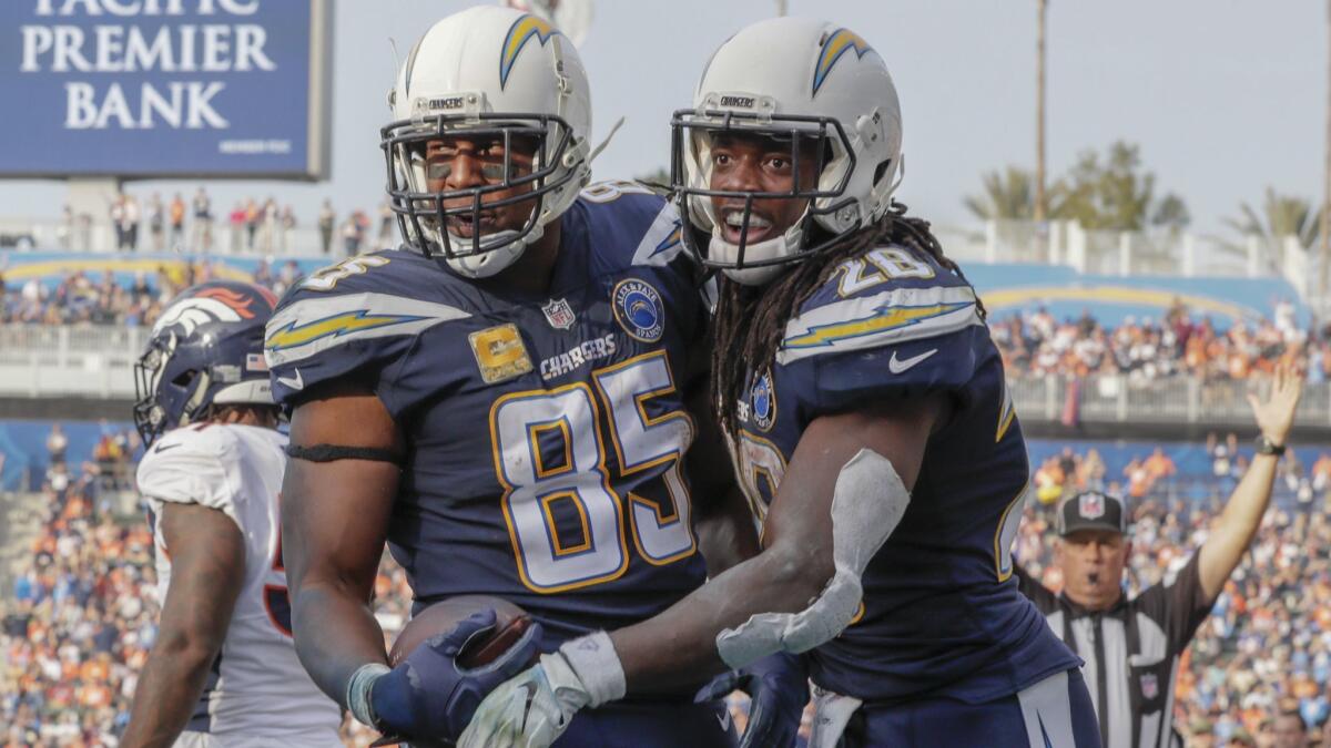 Chargers tight end Antonio Gates is congratulated by Melvin Gordon after catching a six-yard touchdown pass in the third quarter against the Broncos.