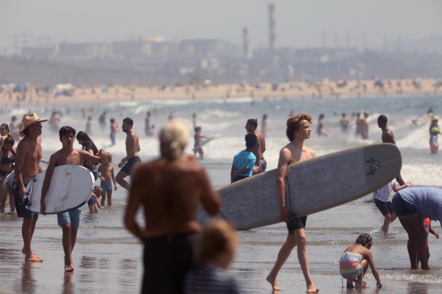 Surfers and beachgoers on Venice Beach.