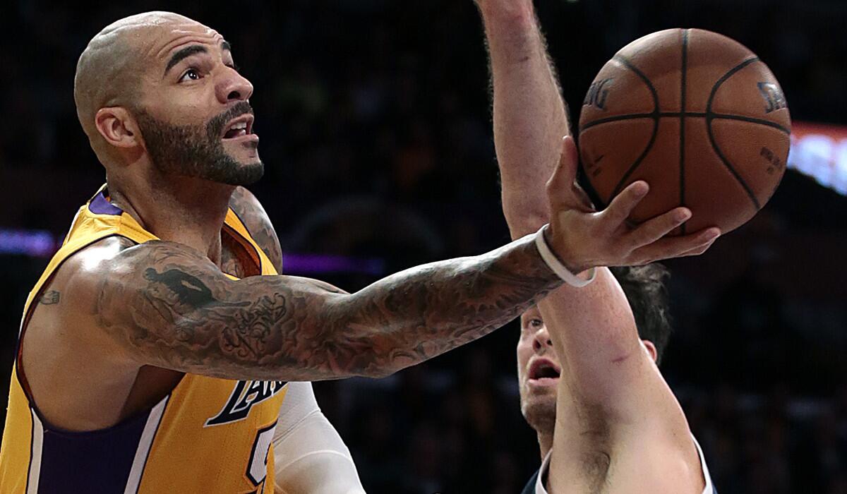 Lakers forward Carlos Boozer goes around Thunder forward Nick Collison for a layup during a game Dec. 19.