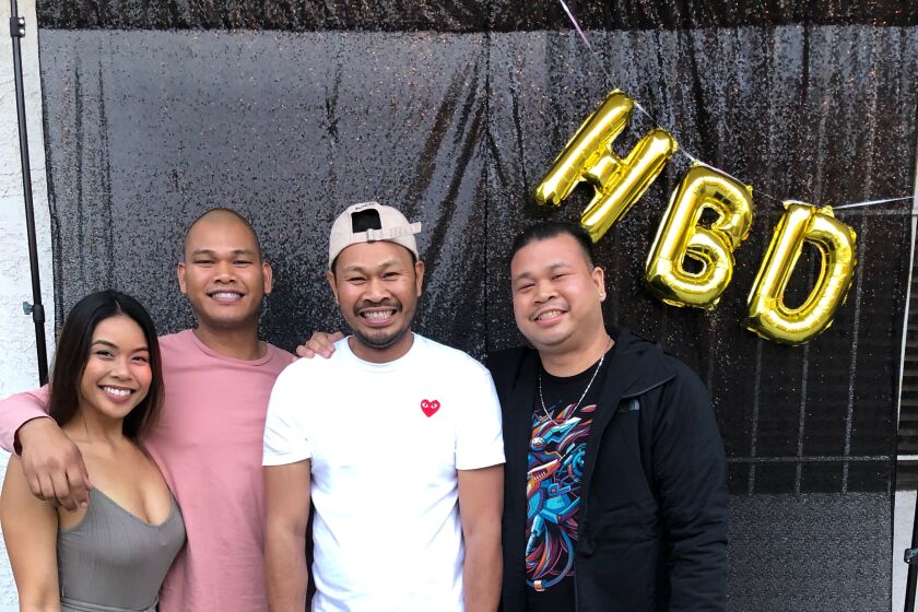 Rickie Chhoeun, in white T-shirt, poses at a birthday party with two brothers and his sister at her Long Beach home, June 2019. CREDIT: Courtesy of the Chhoeun family.