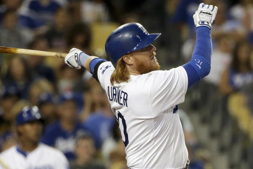 Dodgers third baseman Justin Turner hits a run-scoring double during the fourth inning of Tuesday's game against the San Diego Padres.