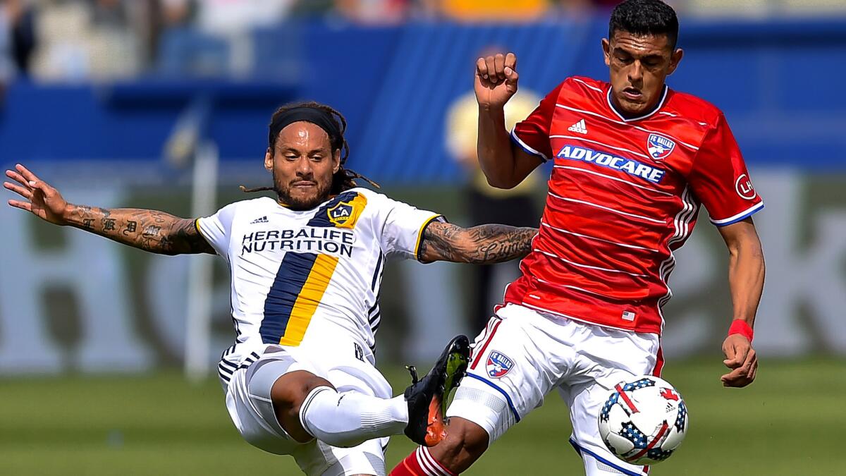 Galaxy midfielder Jermaine Jones kicks the ball away from FC Dallas forward Cristian Colman during the season opener on March 4.