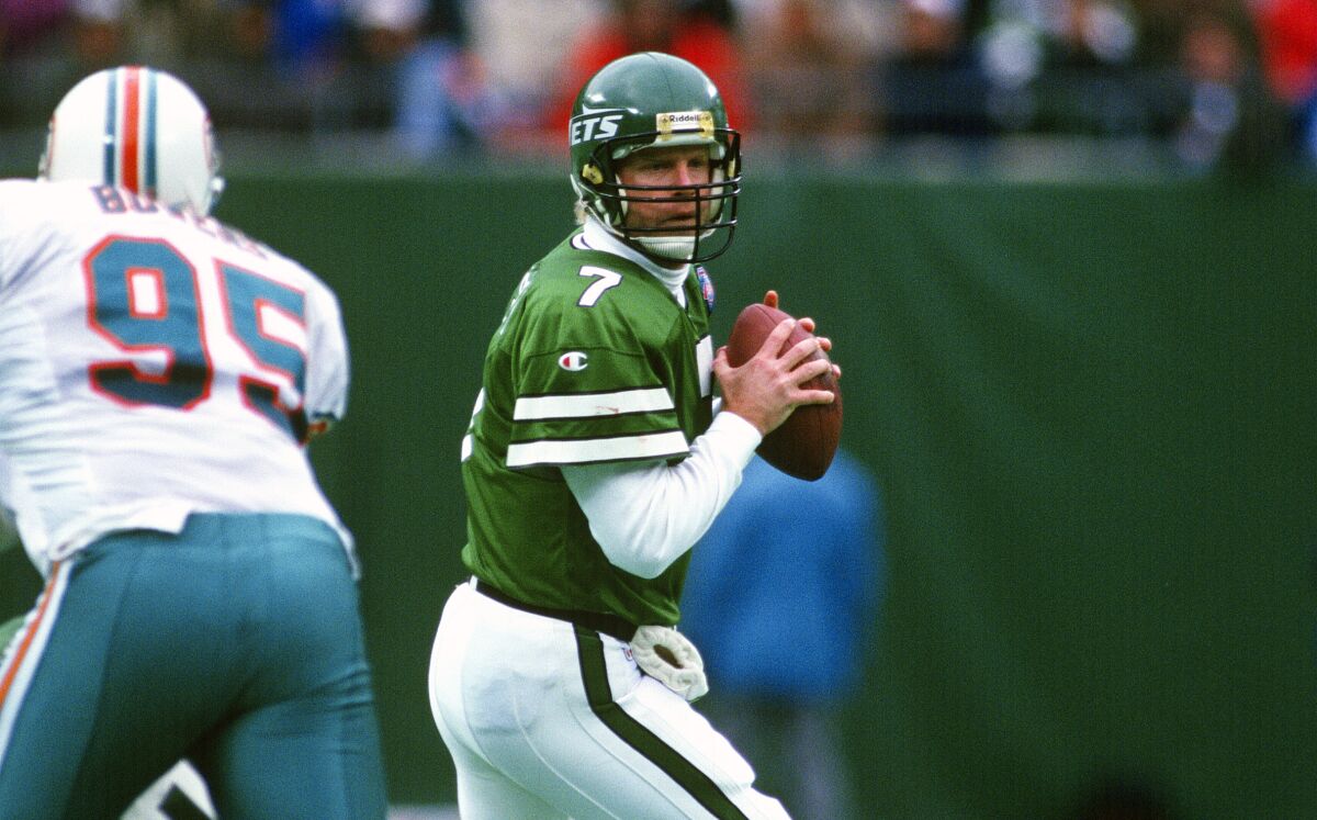 Jets quarterback Boomer Esiason looks to pass against the Dolphins in 1994.