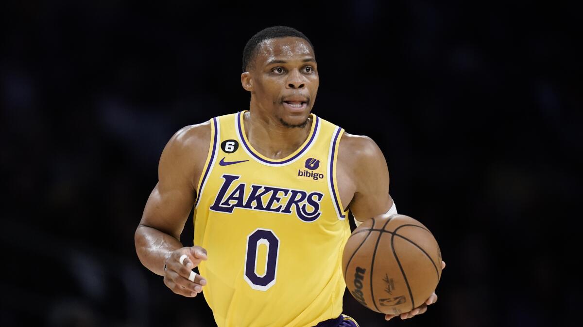 Lakers guard Russell Westbrook dribbles the ball up court.