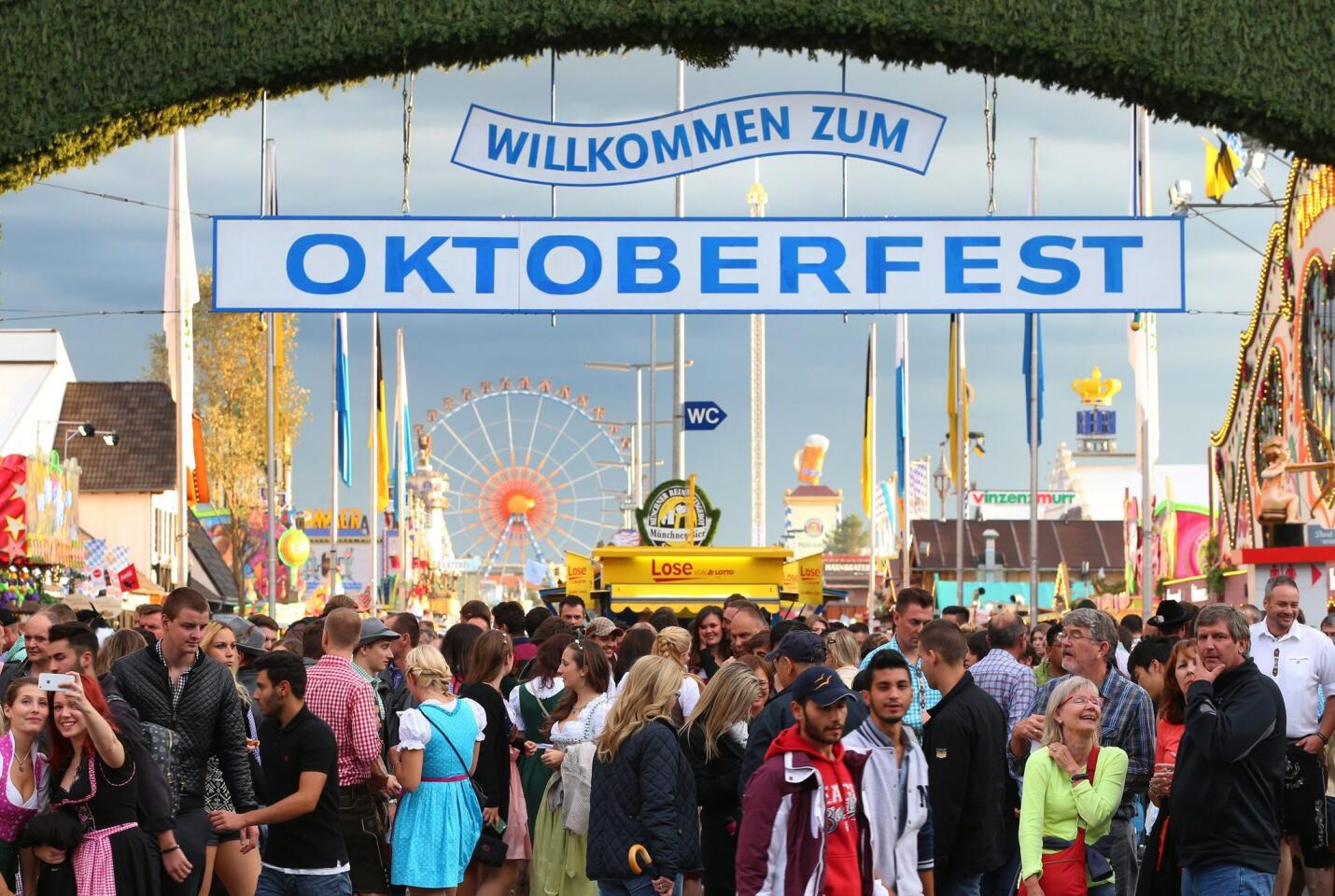 Visitors gather at the main entrance to the venue of the Oktoberfest, known as the 'Wiesn', as part of the 182nd Oktoberfest in Munich, Bavaria, Germany on September 20, 2015.