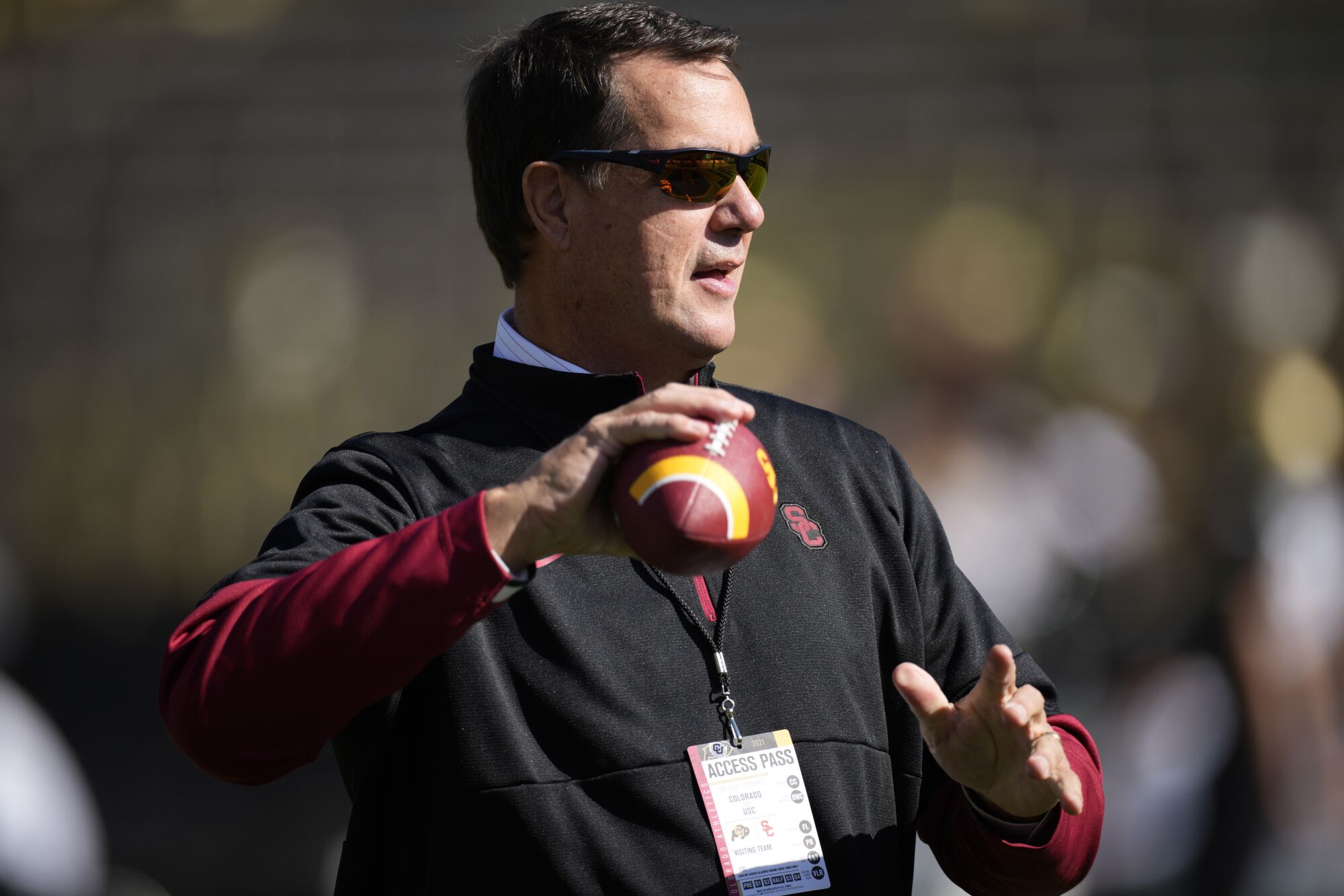 USC athletic director Mike Bohn holds a football
