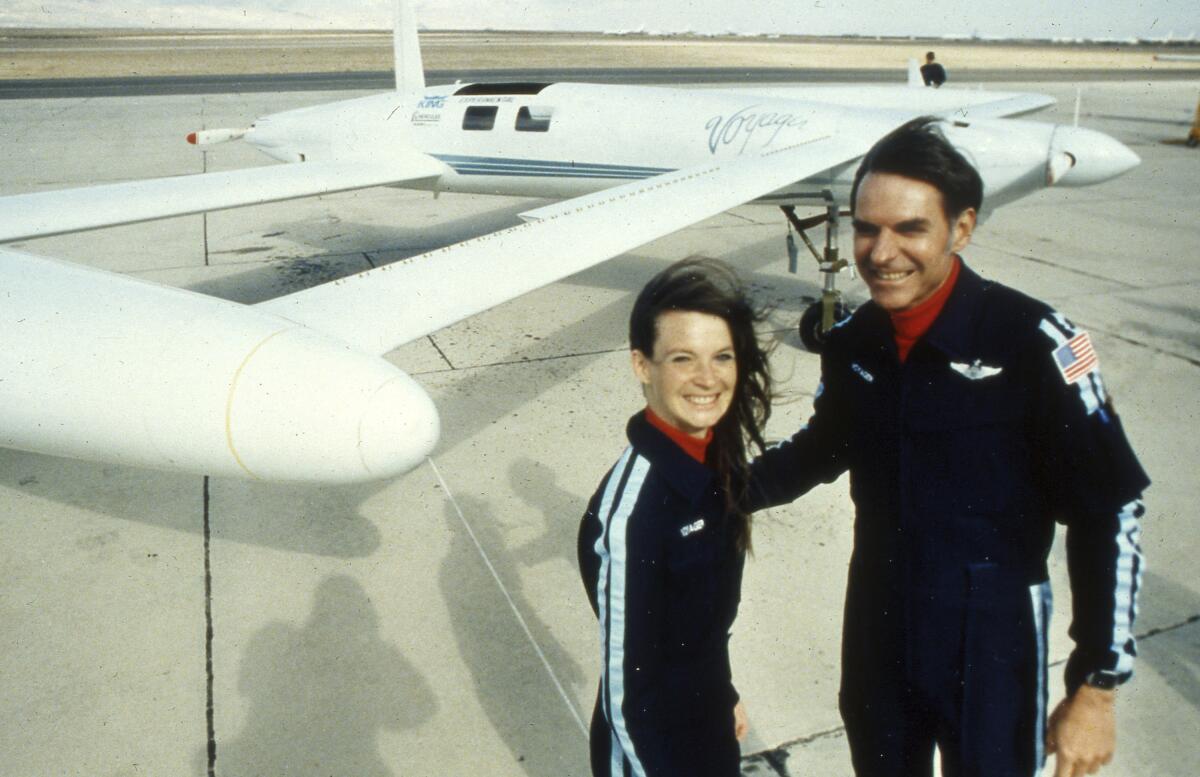 Dick Rutan and Jeana Yeager pose by their Voyager aircraft. 