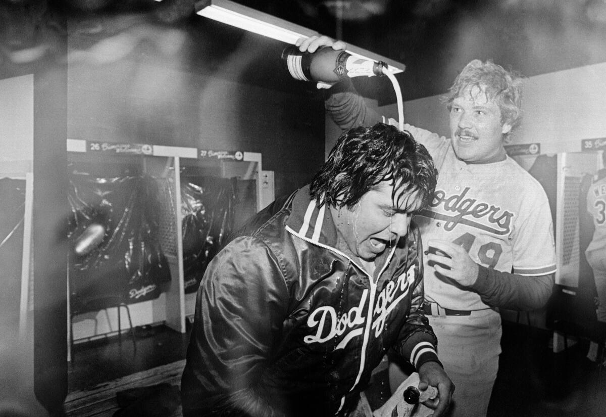 Dodgers pitcher Fernando Valenzuela is doused with champagne by teammate Tom Niedenfuer.