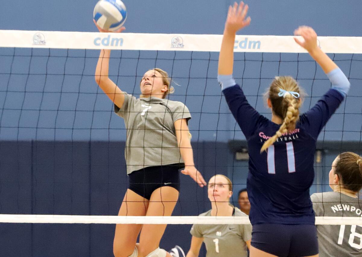 Newport Harbor's Ella Olson (7) taps the ball over the net against Corona del Mar in the Battle of the Bay match on Oct. 12.