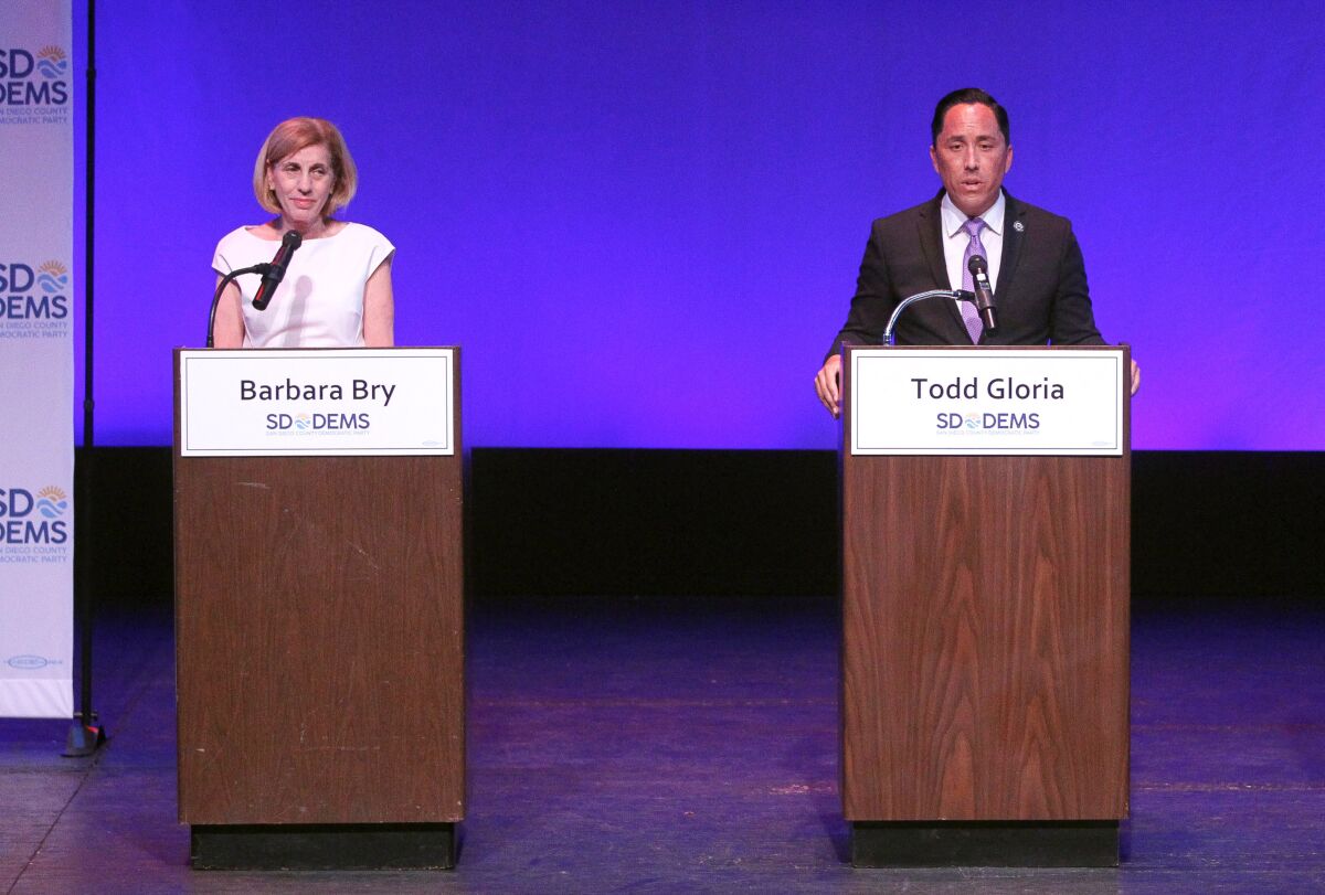 Democratic candidates for the San Diego's mayors race, Barbara Bry and Todd Gloria stand on stage.