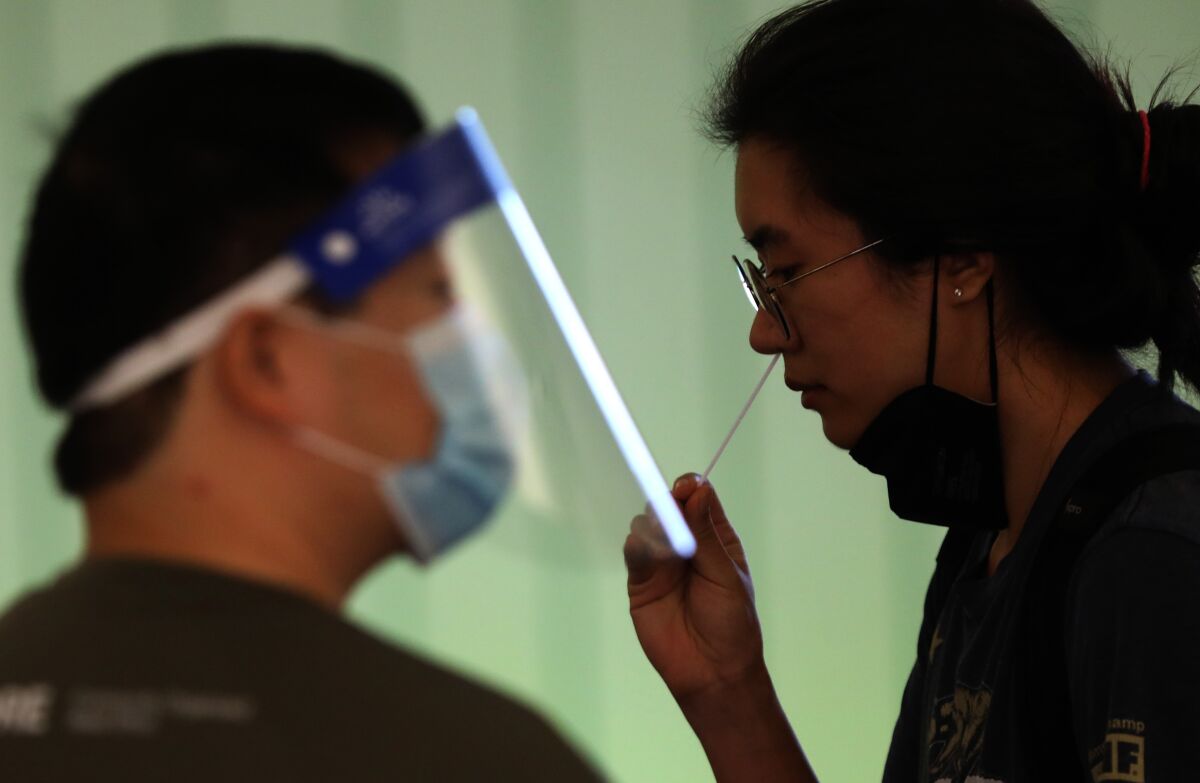 A traveler puts a swag into their nose