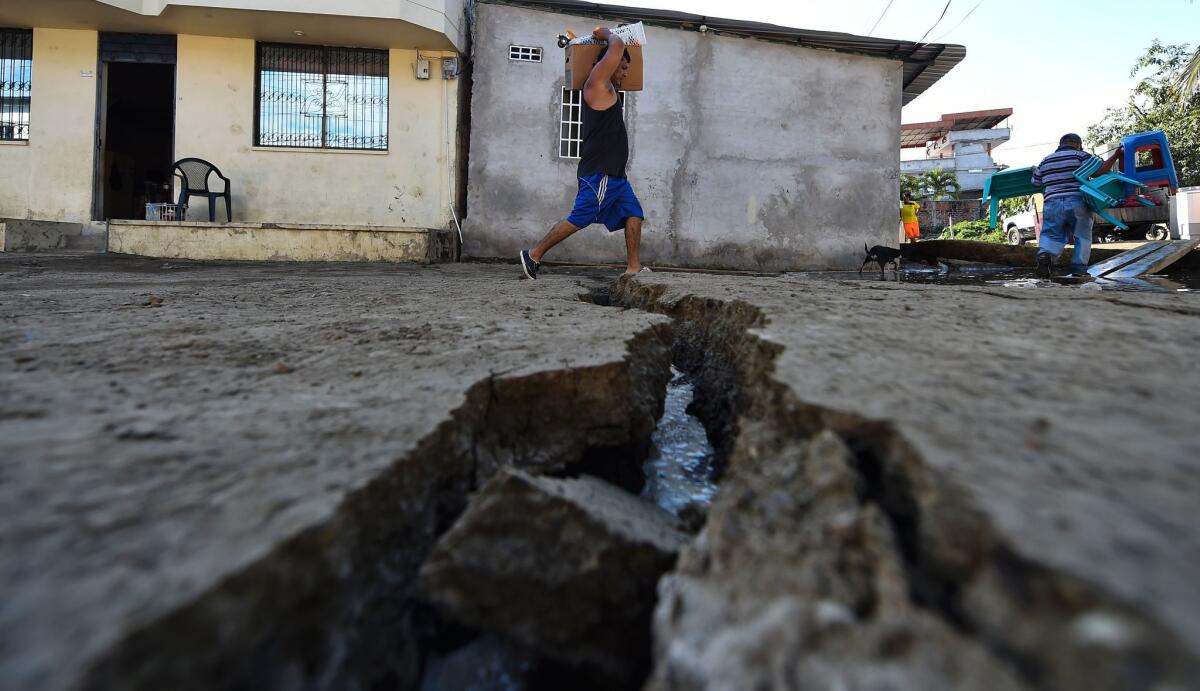 A man evacuates his belongings in Manta, Ecuador, after a powerful 7.8-magnitude quake hit the country.