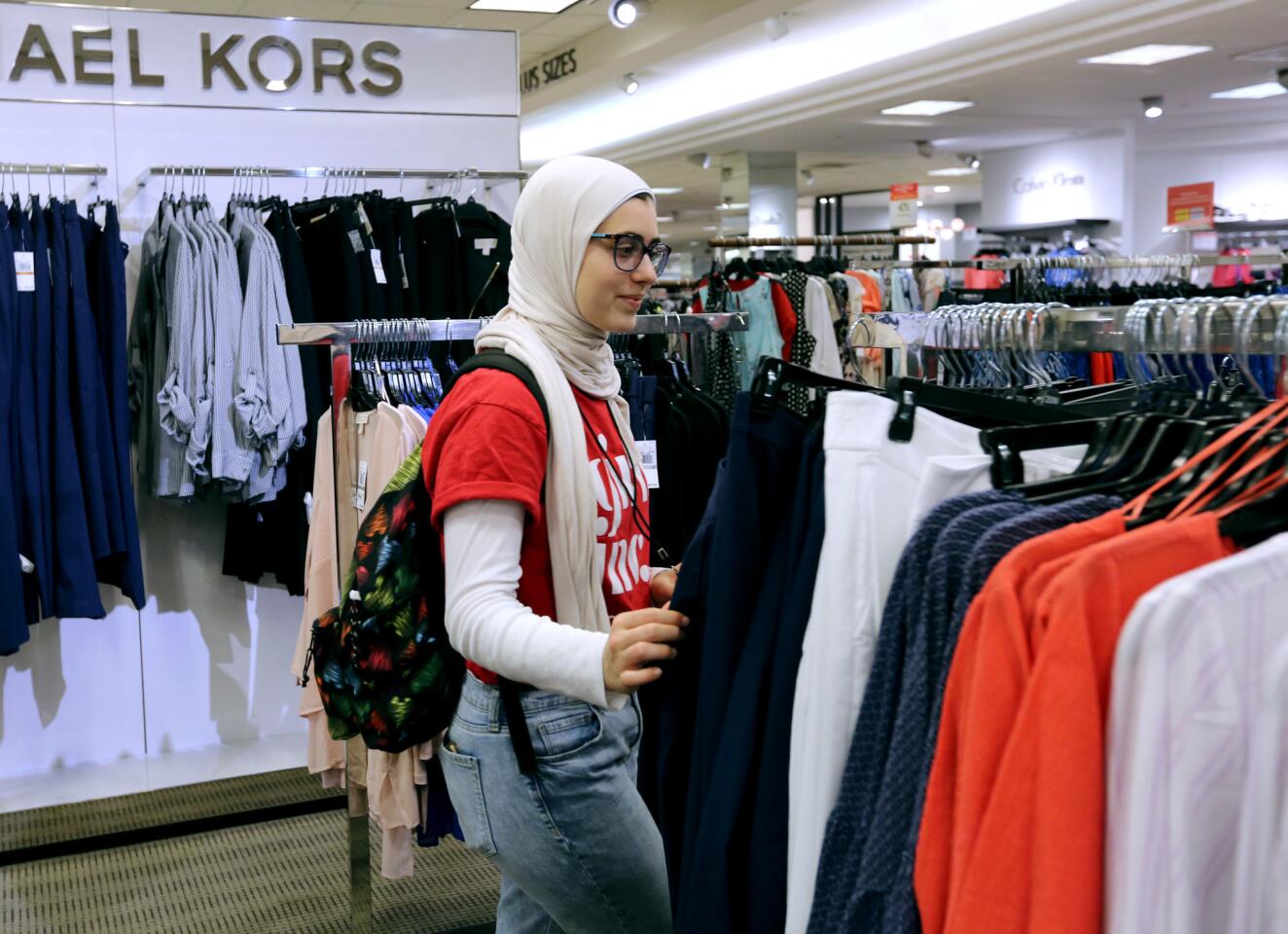 Mariam Al Mounasher shops for clothes Wednesday during Girls Inc. of Orange County's mentoring event at Macy's at South Coast Plaza in Costa Mesa. Ninety-five high school sophomores and juniors participated in interview workshops and style advice to prepare for prospective jobs.