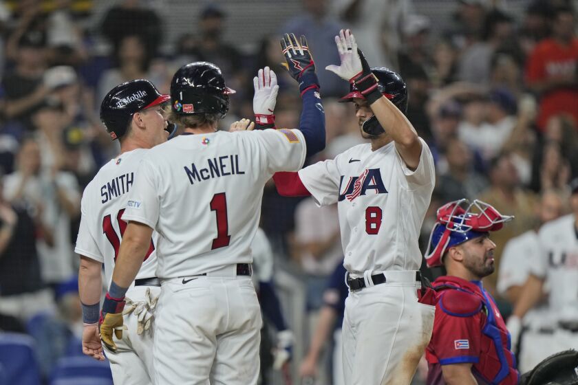 United States' Trea Turner (8) celebrates at home plate after hitting a home run scoring Jeff McNeil (1) and Will Smith (16) during the sixth inning of a World Baseball Classic game against Cuba, Sunday, March 19, 2023, in Miami. (AP Photo/Wilfredo Lee)