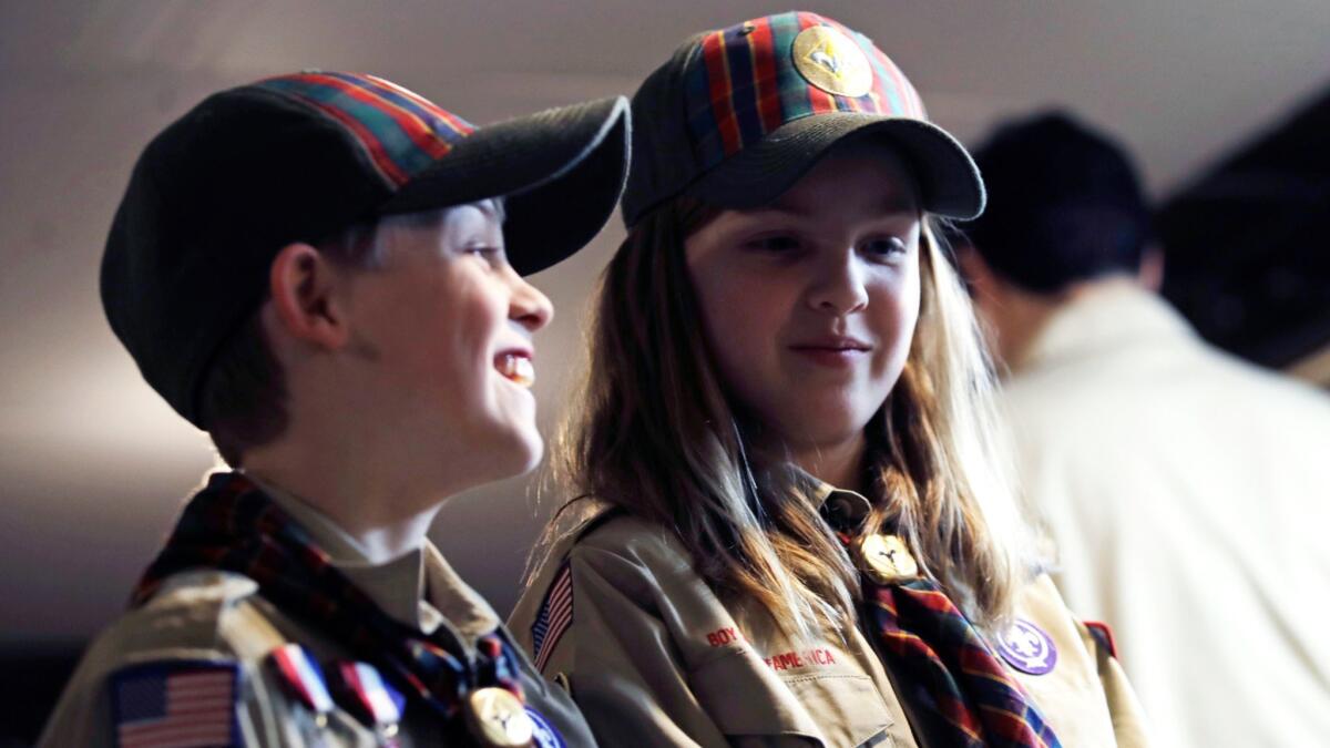 Ian Weir, left, smiles with his sister Tatum during a Cub Scout meeting in Madbury, N.H.