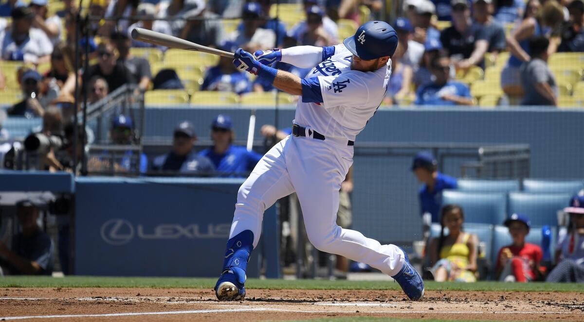 Max Muncy hits a solo home run during the second inning of Sunday's win over the San Diego Padres.