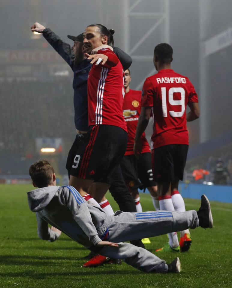 Manchester United's Zlatan Ibrahimovic celebrates scoring their second goal with team mates and fans