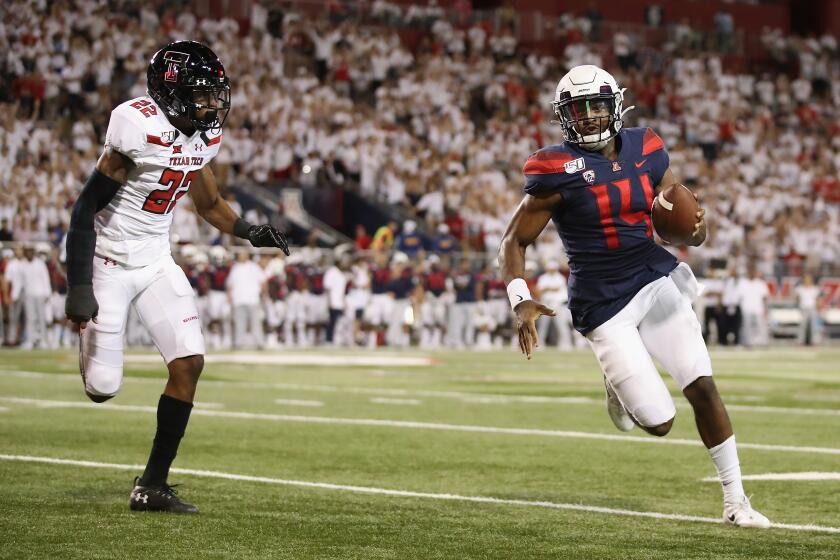 TUCSON, ARIZONA - SEPTEMBER 14: Quarterback Khalil Tate #14 of the Arizona Wildcats rushes the football past cornerback Ja'Marcus Ingram #22 of the Texas Tech Red Raiders during the second half of the NCAAF game at Arizona Stadium on September 14, 2019 in Tucson, Arizona. (Photo by Christian Petersen/Getty Images) ** OUTS - ELSENT, FPG, CM - OUTS * NM, PH, VA if sourced by CT, LA or MoD **