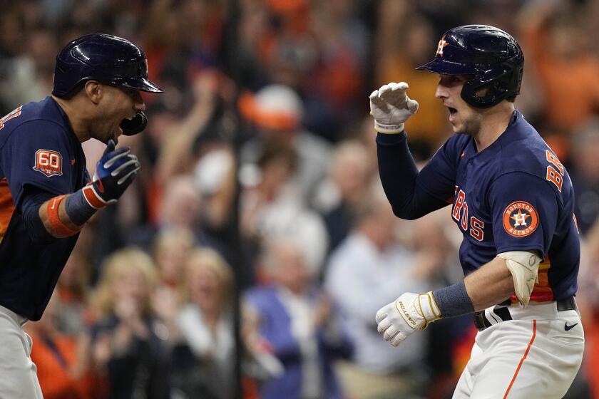 Houston Astros third baseman Alex Bregman, right, celebrates his solo homer during the third inning in Game 2 of baseball's American League Championship Series between the Houston Astros and the New York Yankees, Thursday, Oct. 20, 2022, in Houston. (AP Photo/Eric Gay)