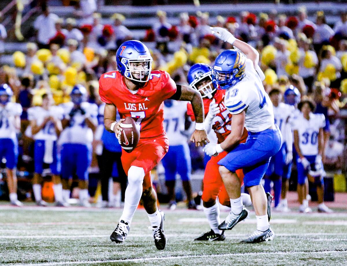 Quarterback Malachi Nelson scrambles from a Santa Margarita defender.