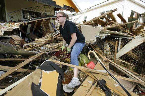 Gina Hadley sifts through her destroyed home in the aftermath of Hurricane Ike in Galveston, Texas. Residents were allowed to return to the island today.