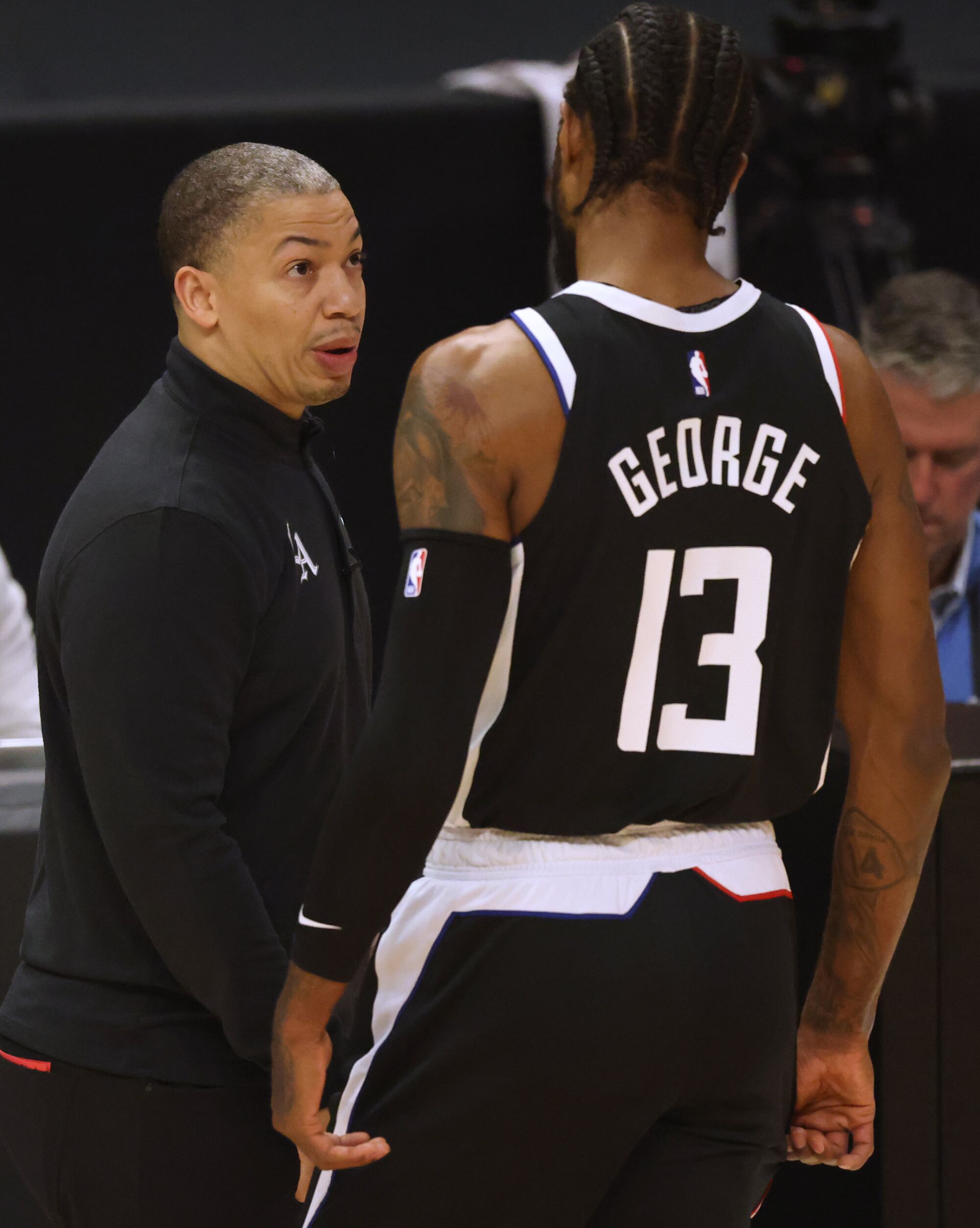 Clippers coach Tyronn Lue talks with Paul George during a break in play.