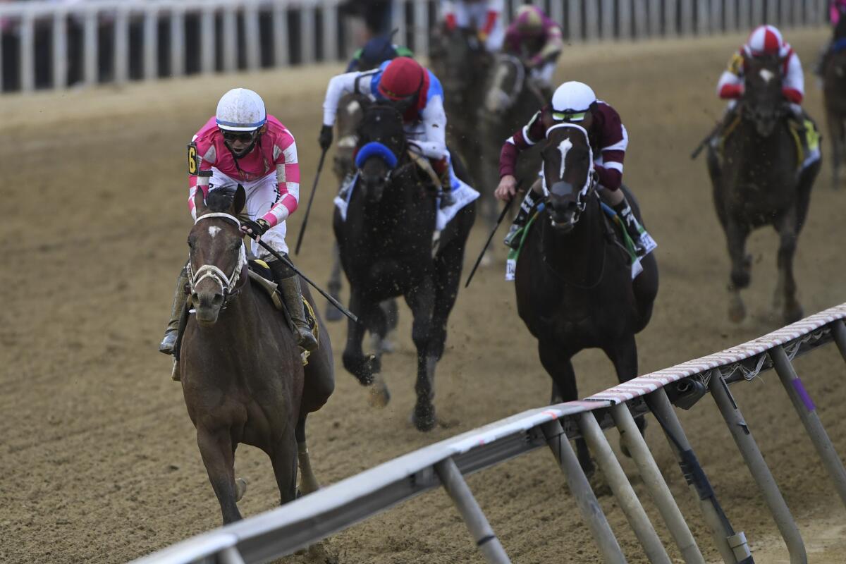 Flavien Prat rides Rombauer, left, to victory in the 146th Preakness Stakes.