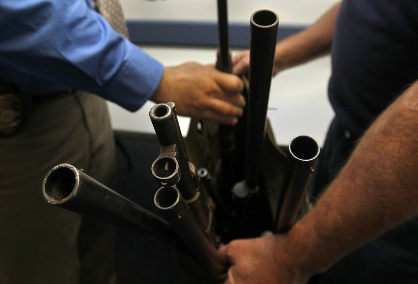 San Diego police officers pack away "long guns" including rifles and shotguns that were bought back in December to get them off the street. Included in the bunch were only two "assault rifles." UT/John Gastaldo/U-T San Diego/JOHN GASTALDO/U-T SAN DIEGO/ZUMA PRESS