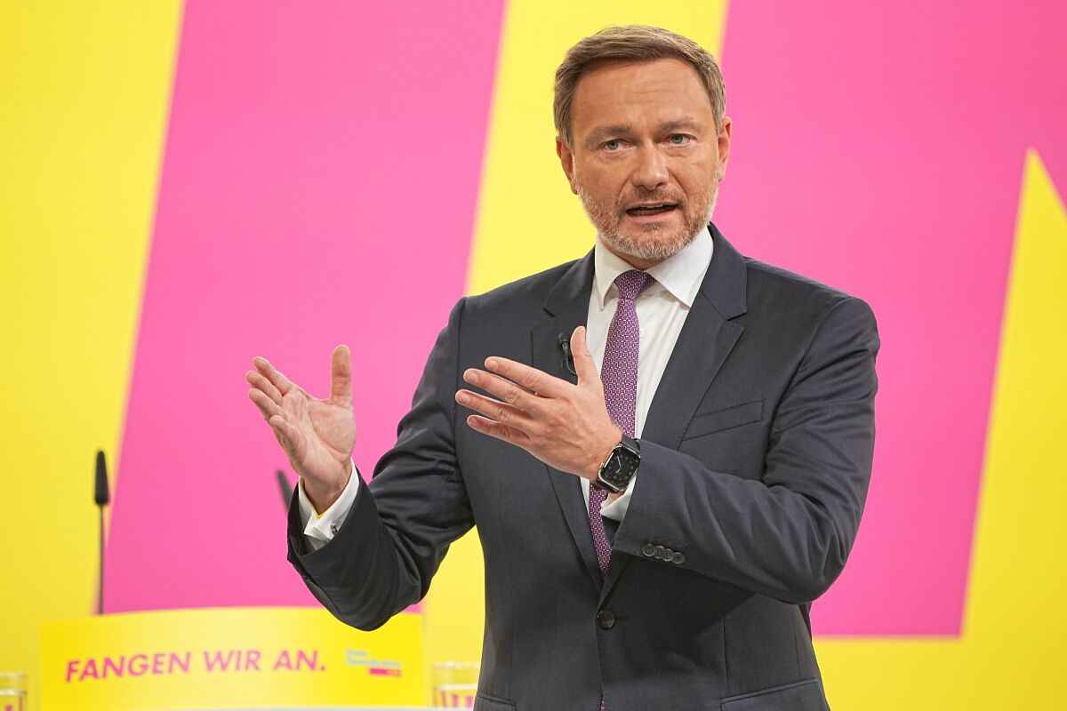 Christian Lindner, the leader of Germany's pro-business Free Democrats, addresses a convention of the party before it decides whether to approve a deal to form a new government with two center-left parties, in Berlin, Sunday, Dec. 5, 2021. The new coalition government under Chancellor-designate Olaf Scholz is expected to take office on Wednesday. (Michael Kappeler/dpa via AP)