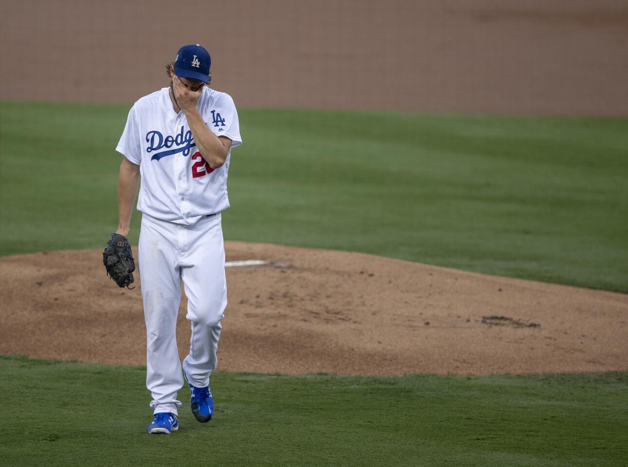 Dodgers starting pitcher Clayton Kershaw wipes his face as he leaves the mound after giving up a two-run home run to Red Sox's Steve Pearce in the first inning.