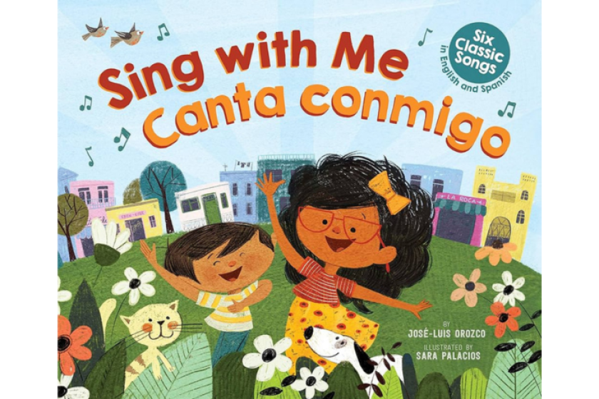 The cover shows two young girls smiling and dancing with a cat in a field of flowers.