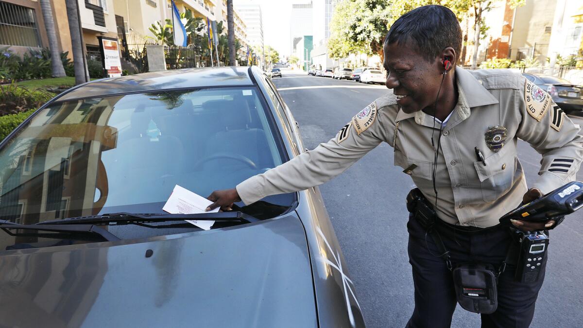 A city traffic officer tickets a vehicle on South Catalina Street near West 5th Streeet.