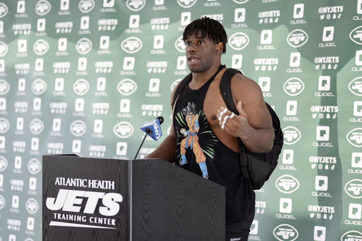 FILE -New York Jets defensive lineman Carl Lawson speaks to the media at the NFL football team's practice facility in Florham Park, N.J., Wednesday, July 27, 2022. Carl Lawson's first season with the New York Jets was over before it even started. The defensive end suffered a ruptured Achilles’ tendon during training camp and was forced to be a spectator. He's healthy and back where he dreamed of being during 12 long months. “I wanted it," he said, "as bad as you want to breathe."(AP Photo/Adam Hunger, File)