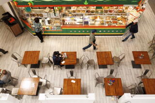 People congregate inside the Asian Garden Mall in Westminster.