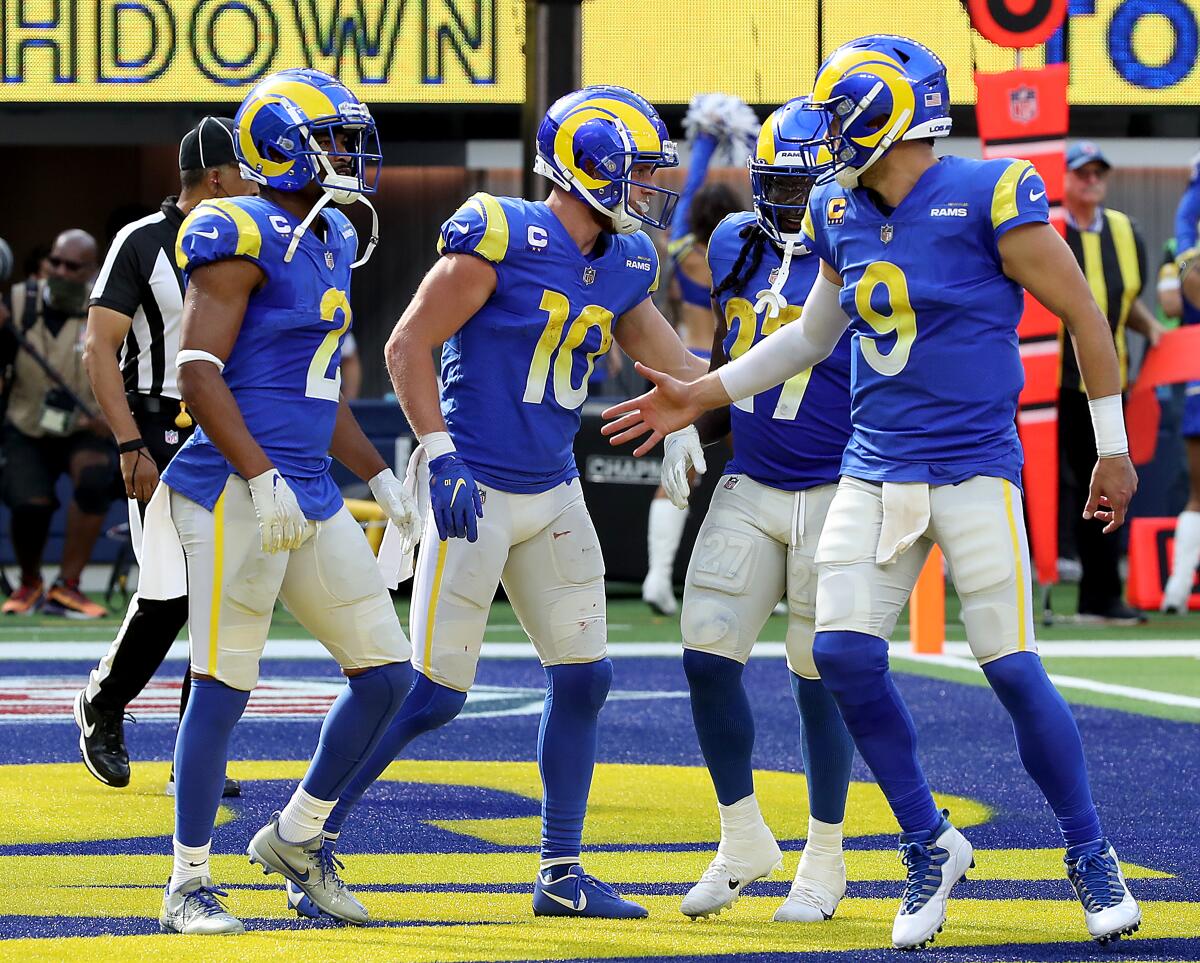 Rams quarterback Matthew Stafford, right, celebrates a touchdown with wide receiver Cooper Kupp.